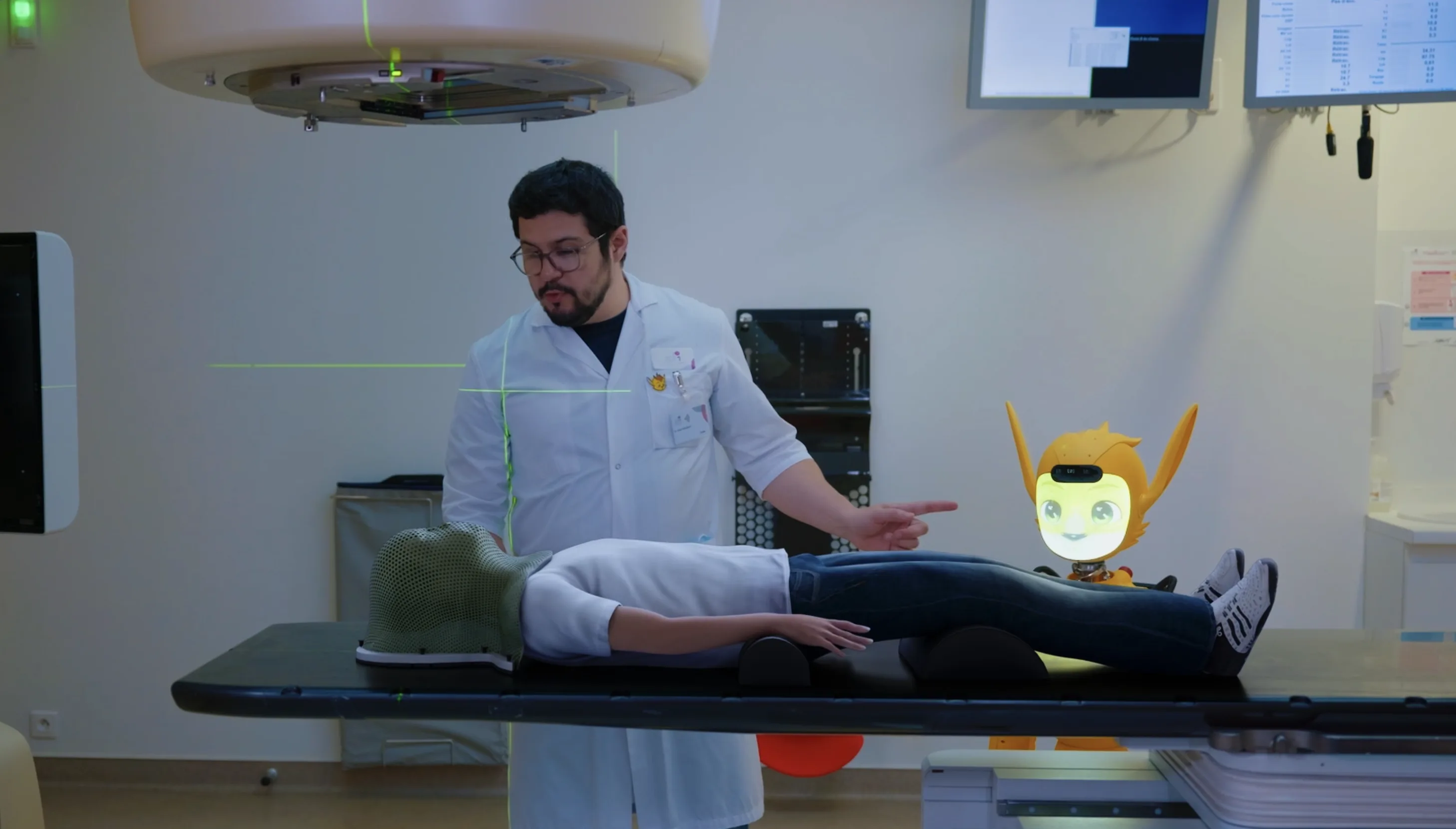 Miroki dans la salle de traitement, à côté d'un enfant et de son médecin.